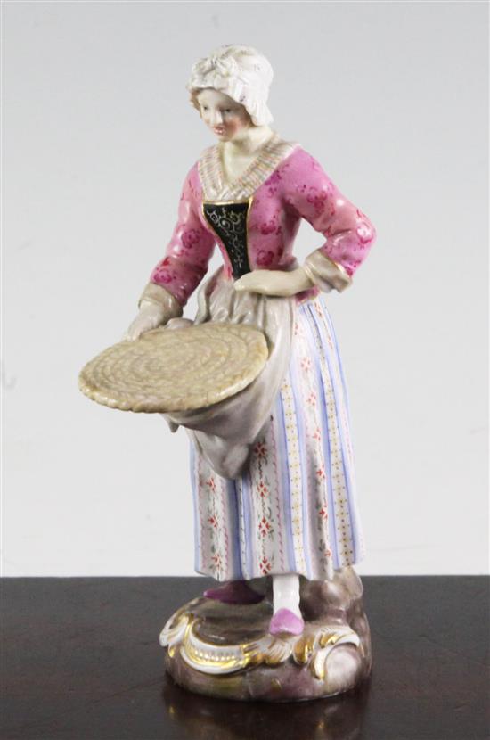 A Meissen figure of a female street vendor, 19th century, 14cm, restored